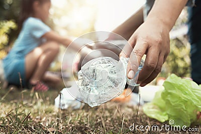 woman hand picking up trash bottle for cleaning Stock Photo