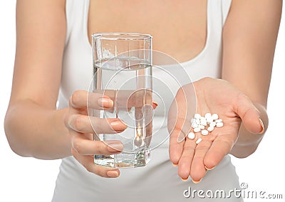 Woman hand with pills medicine tablets and glass of water Stock Photo