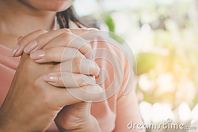 Woman hand praying peacefully outdoors Stock Photo