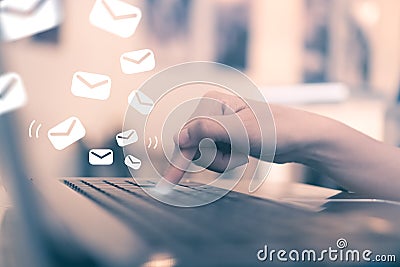 Woman hand push key button on her laptop to send email. Stock Photo