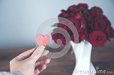 Woman hand red heart with roses Stock Photo