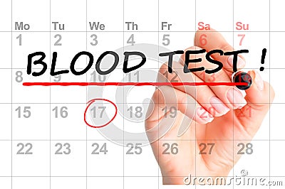 Woman hand with red marker handwriting Blood test reminder on calendar Stock Photo