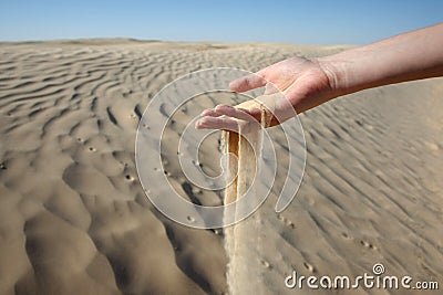 Woman hand in the sand Stock Photo