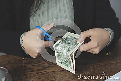 Woman hand scissors with money Stock Photo