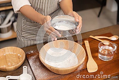 Woman Hand Sifting Bread Flour Before the Process of Kneading Dough Stock Photo