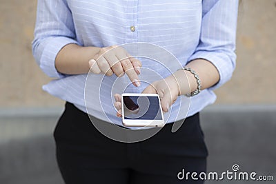 Woman hand smart phone in street Stock Photo