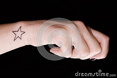 Woman hand with star tatoo Stock Photo