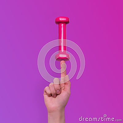 Woman hand taking easy pink dumbbells Stock Photo