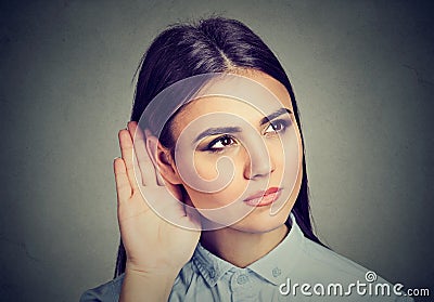 Woman with hand to ear gesture listening carefully Stock Photo