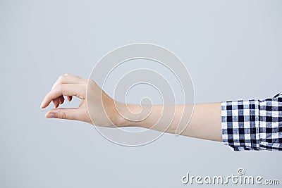 Woman hand to hold something on grey background Stock Photo