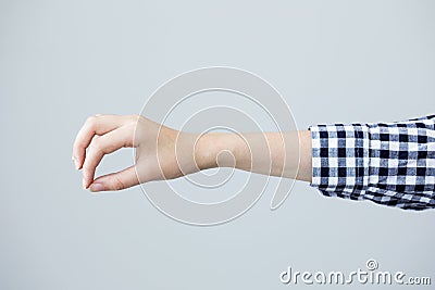 Woman hand to hold something on grey background Stock Photo