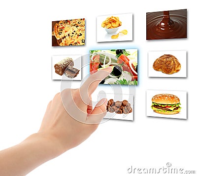 Woman hand uses touch screen interface with food Stock Photo