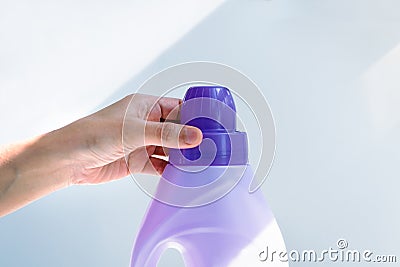 Woman hand using liquid laundry softener detergent washing cloth Stock Photo