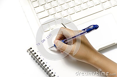 Woman hand writing with pen on notebook Stock Photo