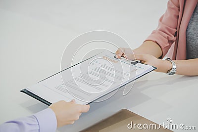 Woman handing job resume to a HR officer Stock Photo