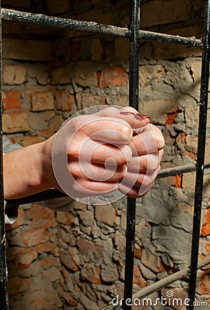 Woman hands behind the bars Stock Photo