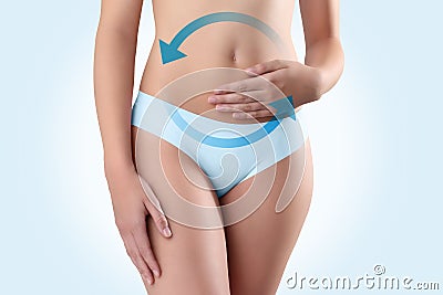 Woman hands on belly with blue arrow Stock Photo