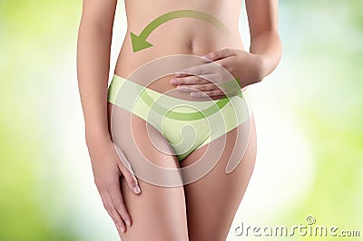 Woman hands on belly with green arrow Stock Photo