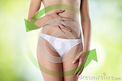 Woman hands on belly with green arrow Stock Photo