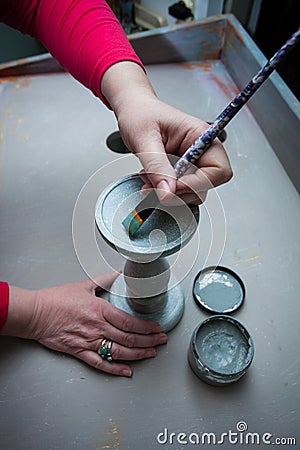 woman hands with brush paint with chalky paint wooden candlestick Stock Photo