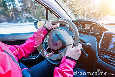 Woman hands on the car steering wheel. Modern car interior with smart dashboard Stock Photo