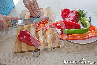 Woman hands cutting vegetables in the kitchen Stock Photo