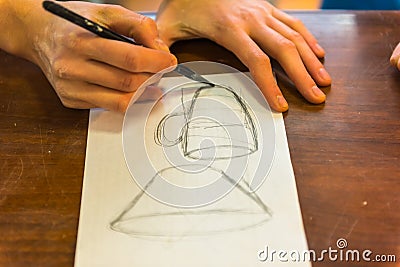 woman hands drawing a draft of a future clay cup Stock Photo