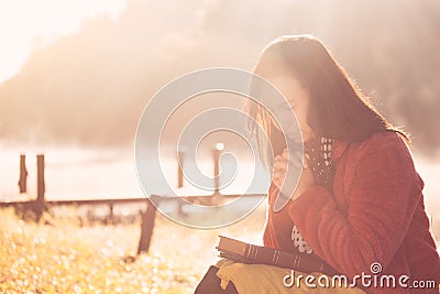 Woman hands folded in prayer on a Holy Bible for faith Stock Photo