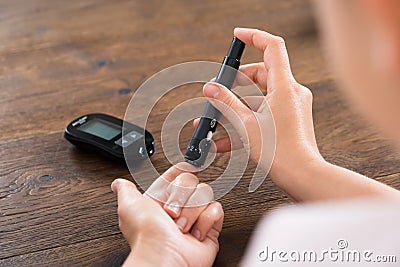 Woman Hands With Glucometer Stock Photo