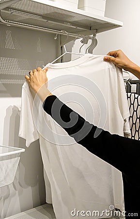 Woman hands hanging t-shirt Stock Photo