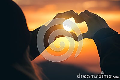 Woman hands Heart symbol shaped silhouette Stock Photo