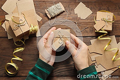 Woman hands hold christmas handmade present box with twine ribbon Stock Photo