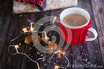 Woman hands holding Christmas coffee or tea red mug with steam, homemade gingerbread christmas cookies on a wooden table, sweeters Stock Photo