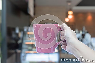 Woman hands holding coffee cup with blurred coffee shop Stock Photo