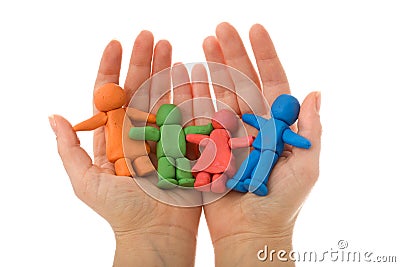 Woman hands holding colorful clay people family Stock Photo