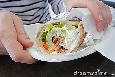 Woman hands holding falafel warp Stock Photo