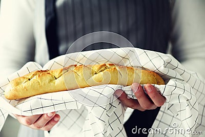 Woman hands holding freshly baked bread. French baguette, bakery concept, homemade food, healthy eating. Copy space Stock Photo