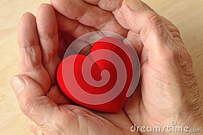 Woman hands holding heart - Concept of love and donation Stock Photo