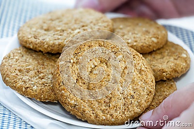 Woman hands holding homemade shortbread cookies made of oatmeal Stock Photo