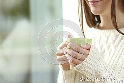 Woman hands holding a hot coffee cup in winter Stock Photo