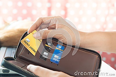 Woman hands holding purse and picking credit card. E-business payment Stock Photo