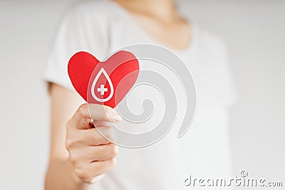 Woman hands holding red heart with blood donor sign. healthcare, medicine and blood donation concept Stock Photo