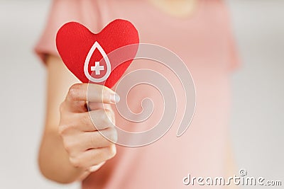 Woman hands holding red heart with blood donor sign. healthcare, medicine and blood donation concept Stock Photo