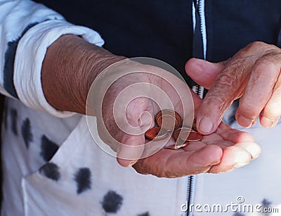 Woman hands holding some euro coins. Pension, poverty, social problems and senility theme Stock Photo