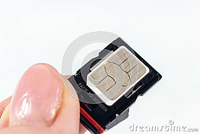 Woman hands inserting the phone sim card into the tray from the smartphone close up. Stock Photo