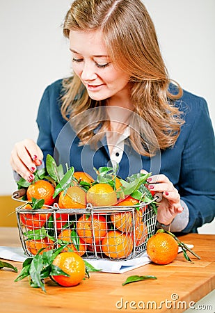 Woman hands with iron basket with fresh clementine copy space Stock Photo