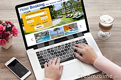 Woman hands on laptop keyboard with online search booking hotel Stock Photo