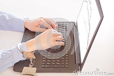 Woman hands locked to laptop by chain on keyboard of notebook Stock Photo