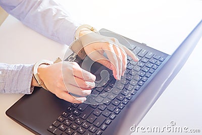 Woman hands locked to laptop by chain on keyboard of notebook Stock Photo