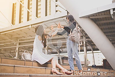 Woman hands meeting,Happy greeting of two friend in the cit Stock Photo